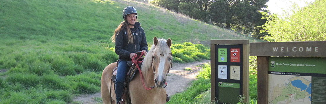 Woman riding a horse at Rush Creek